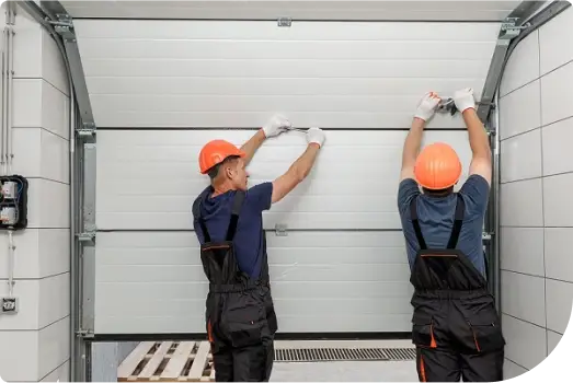 Technicians installing a new garage door
